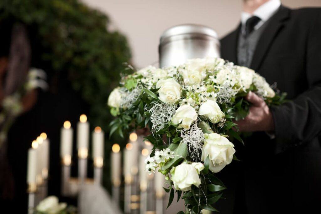 funeral director holding cremation urn